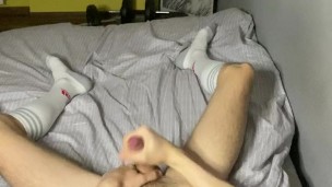 Boy in long white socks plays with his cock with a shot