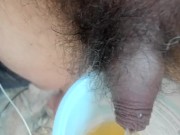 pissing in a yoghurt pot