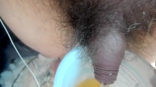 pissing in a yoghurt pot