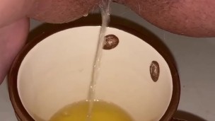 Girl pisses in a coffee cup