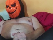 Man in Halloween mask and nylon tights pleasuring himself...