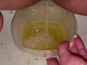 Babe does close up piss in Tupperware container 8/16