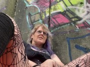 MILF fucks herself by busy mall