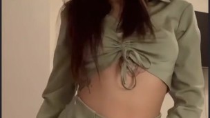 a beautiful brunette in a beautiful green suit.