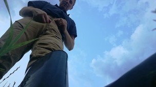 Farmer shows his dirty rubber boots and pee huge in the wheat field