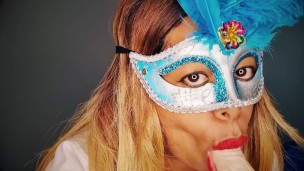 Masked milf sucks a dildo while looking into your eyes