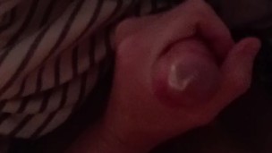 Playing with thick mushroom-headed cock in a tight condom