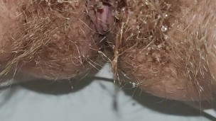 Hairy milf takes out a pink menstrual cup and pees on last day of period