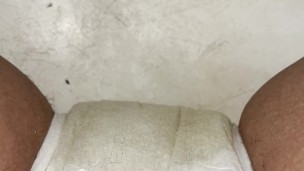 Girl having a smoke while peeing in her diaper