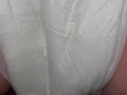 Girl pisses in diaper close up from behind