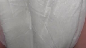 Girl pisses in diaper close up from behind