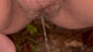 Girl pees on the leaves outside closeup pussy with a little hair