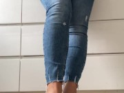 Woman in blue jeans and flip-flops in the kitchen do normal things and showing her feet barefoot