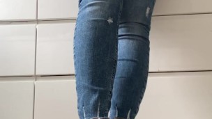 Woman in blue jeans and flip-flops in the kitchen do normal things and showing her feet barefoot