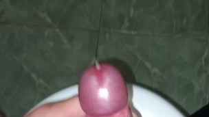 The guy masturbates his penis and cums