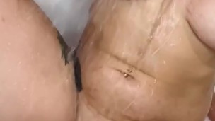 I gently wash my breasts in the bath and stimulate my cunt with a stream of water