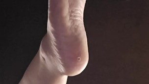 Bored goth girl ignores you under her desk dangling feet and flipping you off