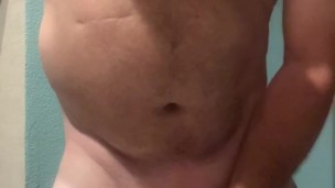 Sexy daddy bear Maxwell Cox strips out of his tiny g string and plays with his cock