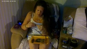 Busty girl in pink bra and panties smoking and playing video games