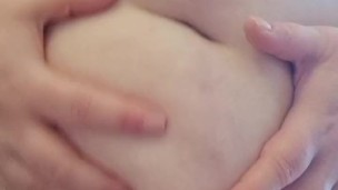 A fat woman with a hairy pussy kneads, massages and strokes her big belly with a scar