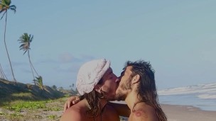Deep tongue kiss at public nudist beach