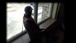 showing off wetsuits at hotel window
