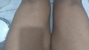 Black muscular boy showing his feet and his big legs