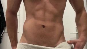 Young muscle hunk show off in the bathroom