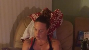 Beautiful girl in black mini dress lifts up her dress and play fortnite while smoking cigarettes