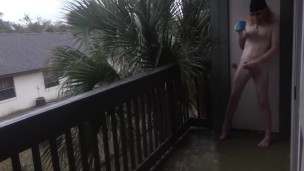 Nudist enjoys his morning wood with coffee on the balcony