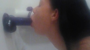 Sucking purple suction cup dildo in tub