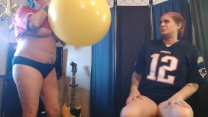 Lesbians Blowing up Big Yellow Balloon Superbowl Party Prep