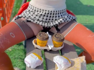 Naked drinking coffee in the park