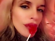 Hot blonde milf sexily sucks a lollipop in front of everyone in a cafe 13/16