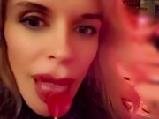 Hot blonde milf sexily sucks a lollipop in front of everyone in a cafe 3/16