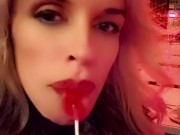 Hot blonde milf sexily sucks a lollipop in front of everyone in a cafe 4/16