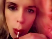 Hot blonde milf sexily sucks a lollipop in front of everyone in a cafe 5/16