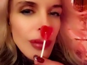 Hot blonde milf sexily sucks a lollipop in front of everyone in a cafe 7/16