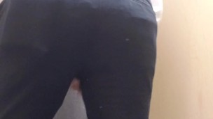 in the store dressing room trying on some pants