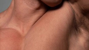 Fitness model licking his own biceps