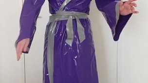 Putting on latex saint priest robe coat gown over schoolgirl sailor uniform and rubber skirt layers