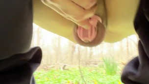 Caged cuck flashes while walking in woods