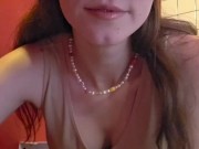 Charming girl takes off her bra from under her T-shirt 1/16