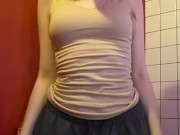 Charming girl takes off her bra from under her T-shirt 12/16