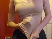 Charming girl takes off her bra from under her T-shirt 14/16