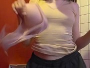 Charming girl takes off her bra from under her T-shirt 16/16