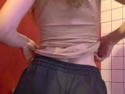 Charming girl takes off her bra from under her T-shirt 8/16