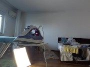 Amateur mom does chores in the naked house.