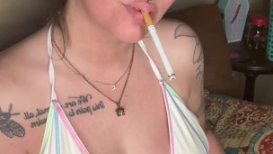 brunette babe smoking a cigarette in a bikini - full vids are on OF CheryTrees