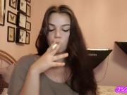 Teen latina brunette with blue eyes teases you with slow, seductive smoking 2/16